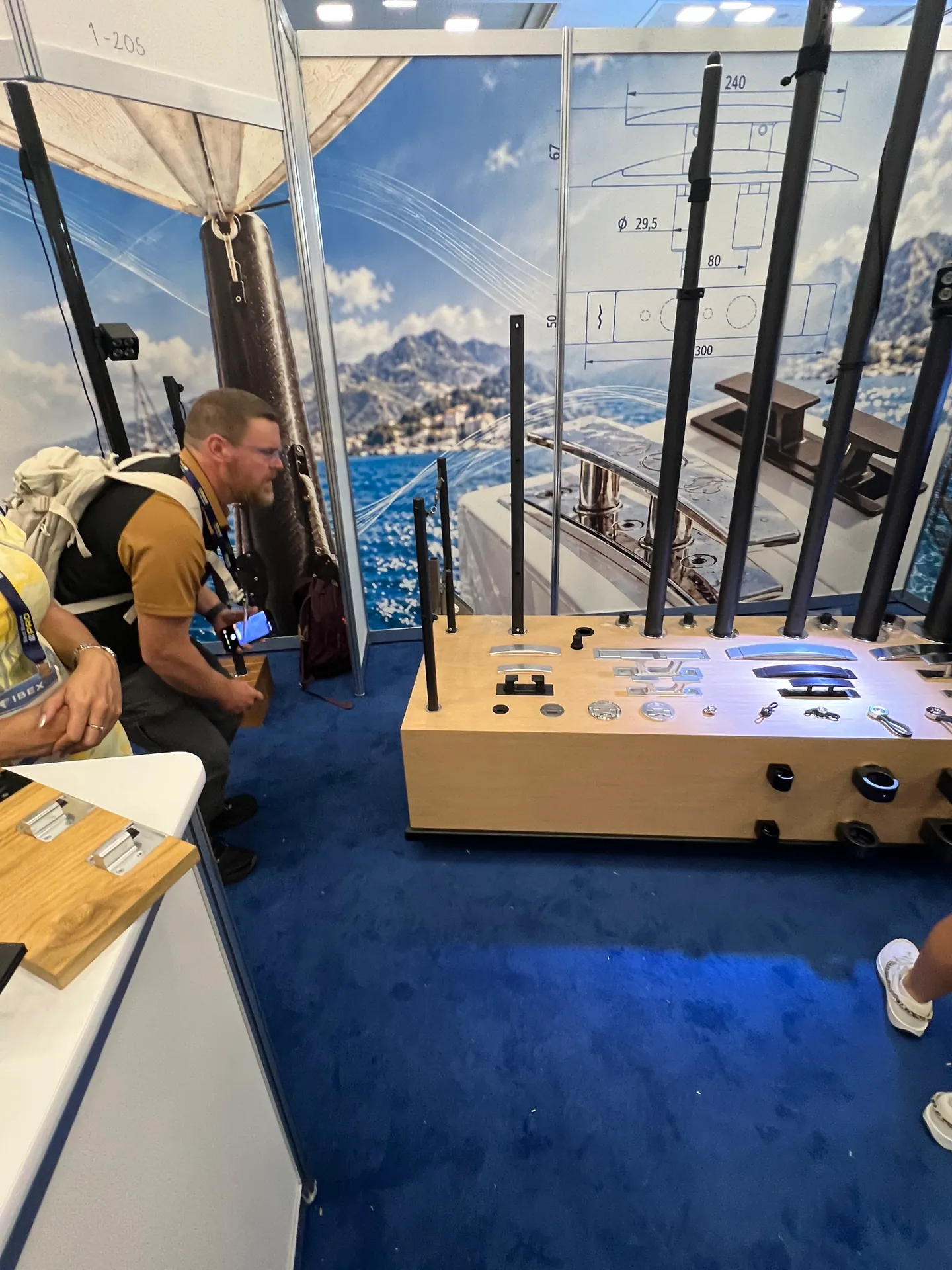 A visitor taking a closer look at the deck fittings and poles on the Yachtify display.