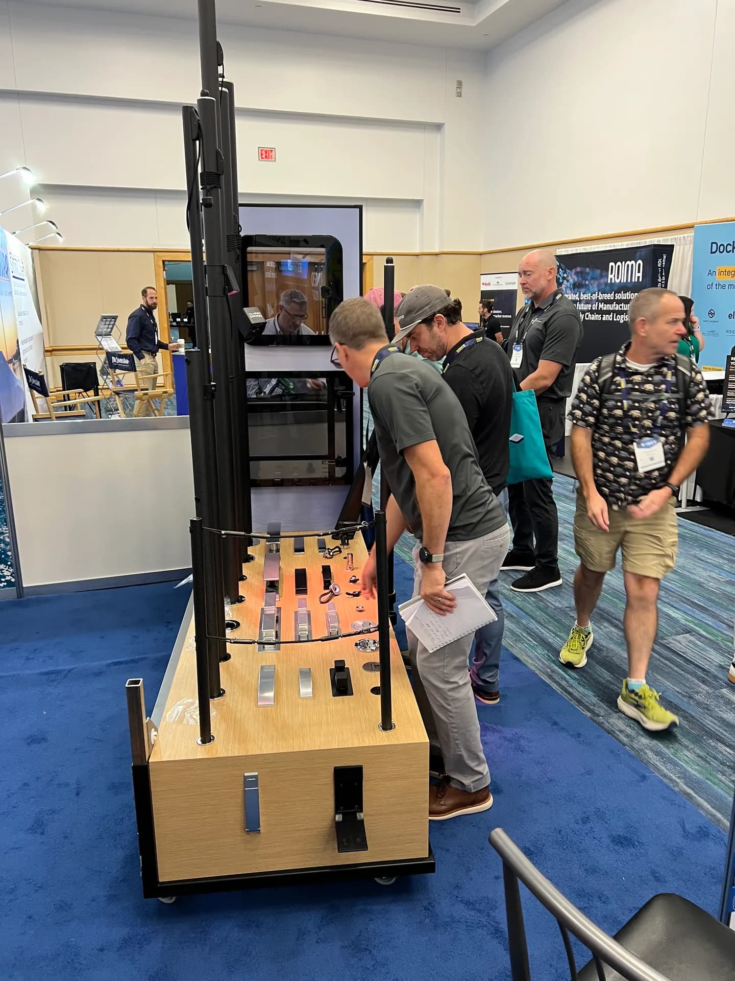 Show visitors examining the marine hardware display at Yachtify’s IBEX stand.