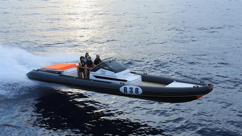 Rigid inflatable boat underway across open water.