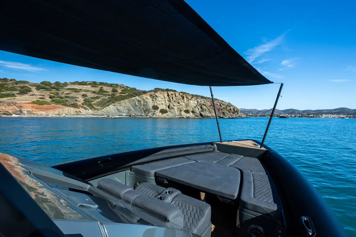Fabric canopy shading a cockpit beside turquoise water
